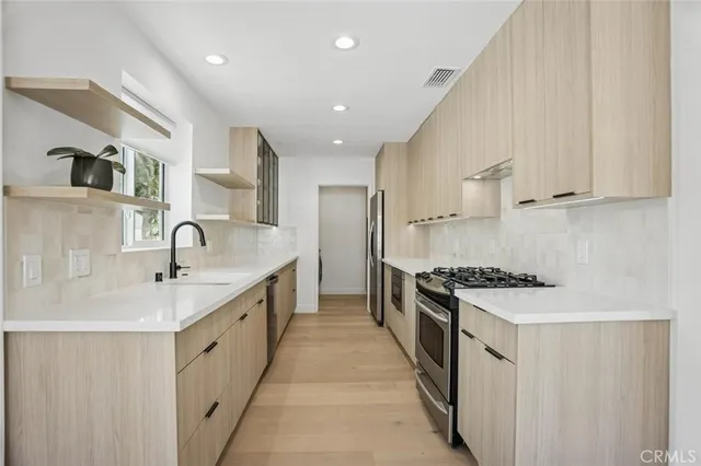 a kitchen with granite countertop a sink and cabinets