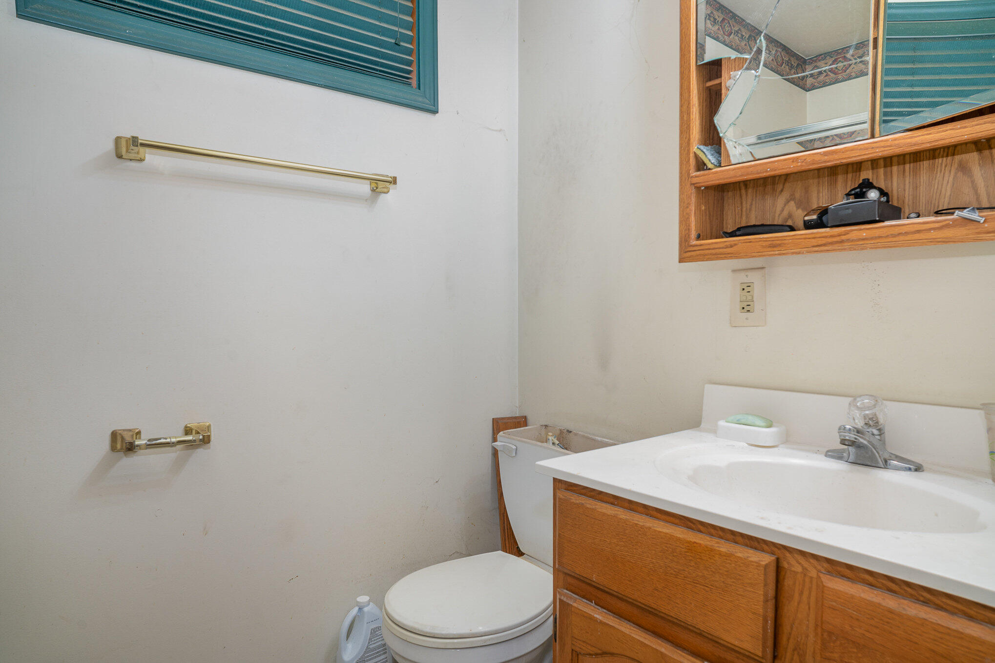 737 Center Street Crown Point, IN 46307 - Photo 7 of 10 a bathroom with a granite countertop sink toilet and a mirror