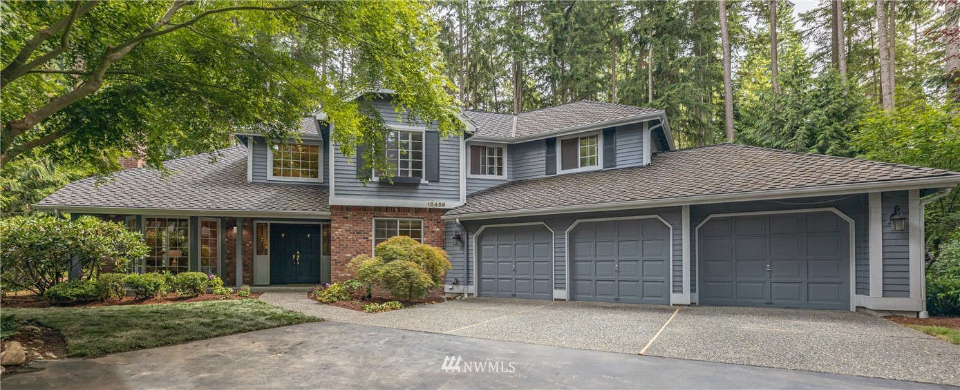 18459 Northeast 196th Place Woodinville, WA 98077 - Photo 1 of 40 a front view of a house with a garden
