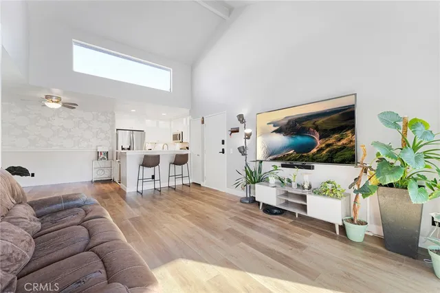a living room with furniture fireplace and wooden floor