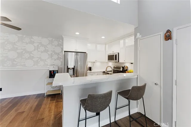 a kitchen with stainless steel appliances a refrigerator and a stove top oven