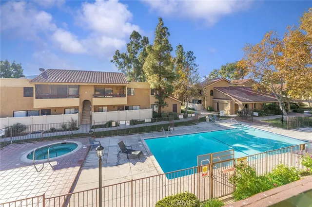 a view of a house with swimming pool and sitting area
