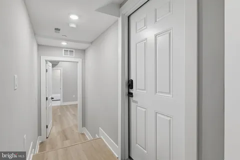 an empty room with windows and closet