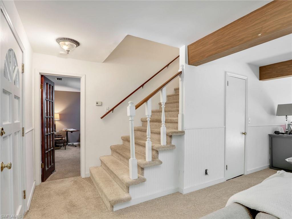 210 25th Street Southwest Naples, FL 34117 - Photo 15 of 33 Stairway featuring carpet flooring and a wainscoted wall
