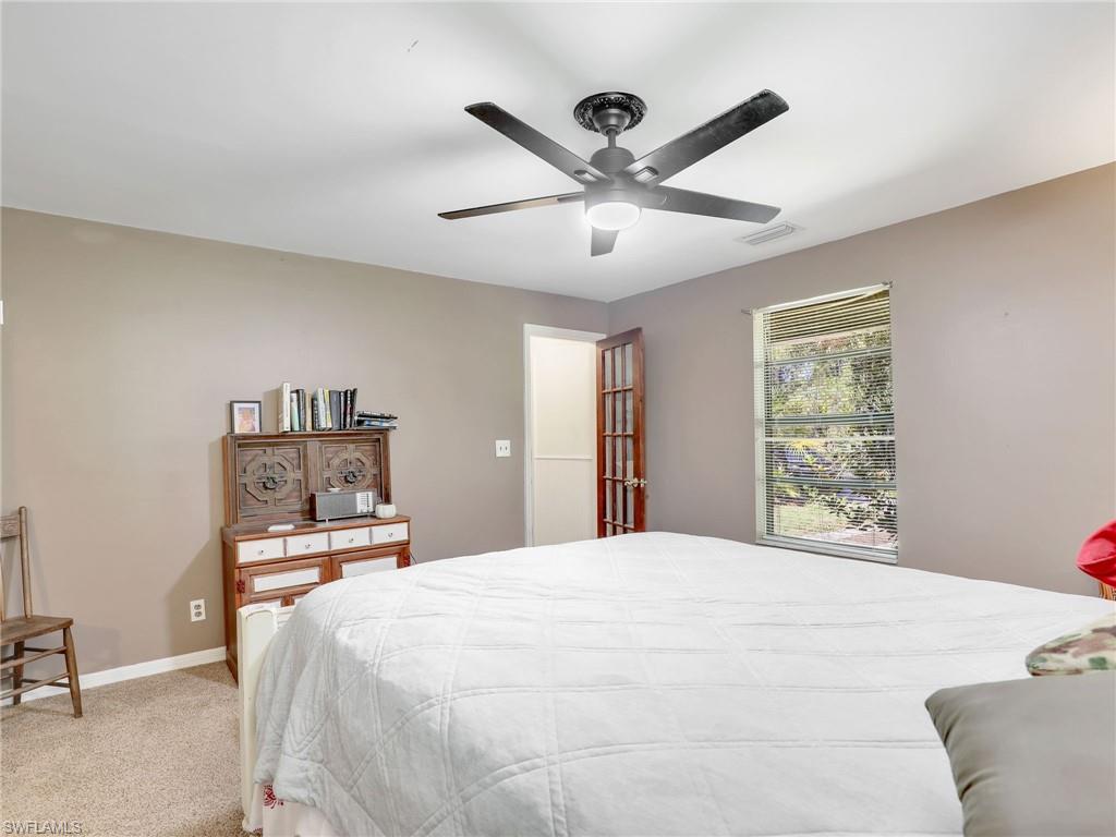 210 25th Street Southwest Naples, FL 34117 - Photo 17 of 33 Carpeted bedroom with a ceiling fan and baseboards
