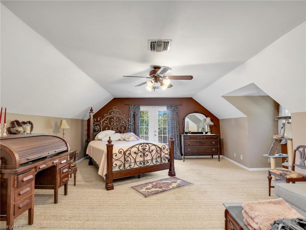 210 25th Street Southwest Naples, FL 34117 - Photo 20 of 33 Bedroom with light colored carpet, lofted ceiling, ceiling fan, and access to outside
