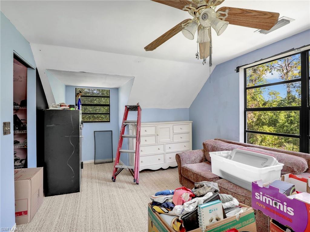 210 25th Street Southwest Naples, FL 34117 - Photo 23 of 33 Carpeted bedroom featuring vaulted ceiling and a ceiling fan