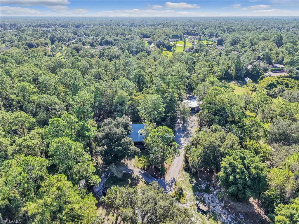 210 25th Street Southwest Naples, FL 34117 - Photo 5 of 33 Aerial view of property and surrounding area with a forest
