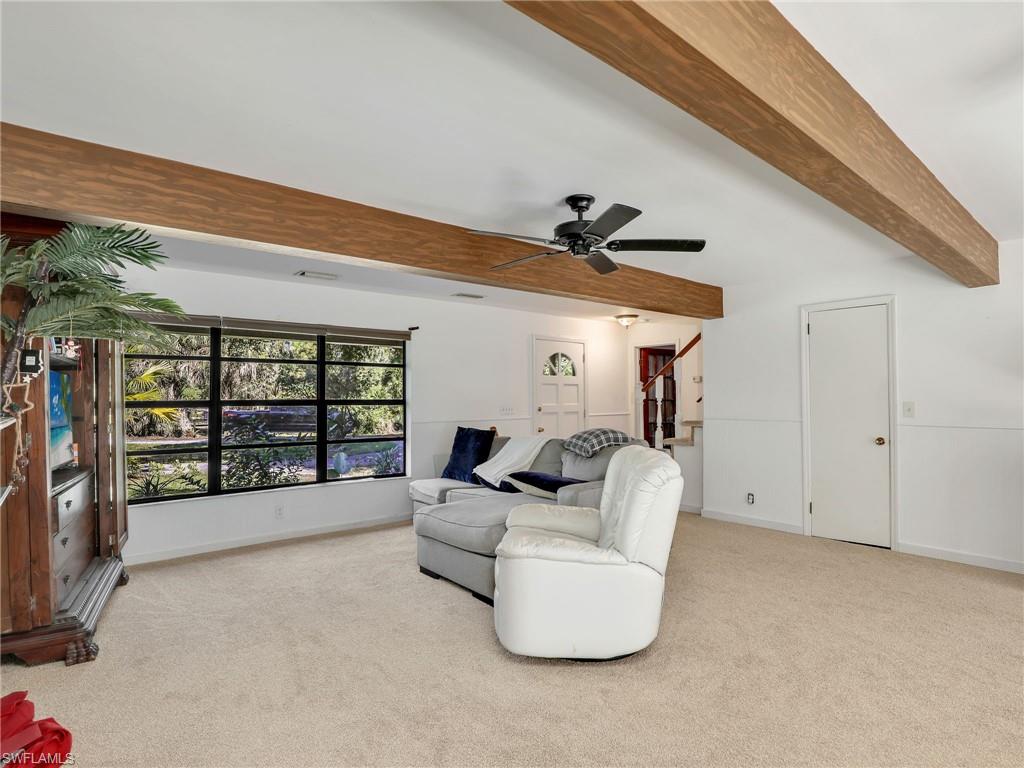 210 25th Street Southwest Naples, FL 34117 - Photo 7 of 33 Living area with beamed ceiling, light colored carpet, and a ceiling fan