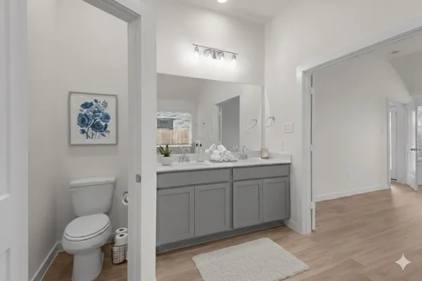 a bathroom with a tub sink and mirror