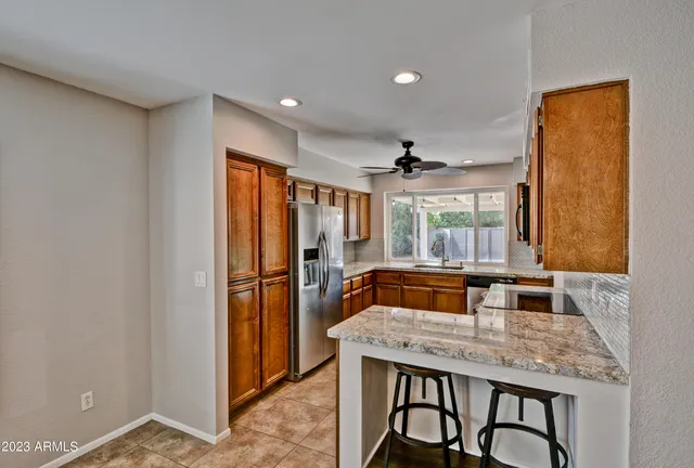 a kitchen with a table and chairs