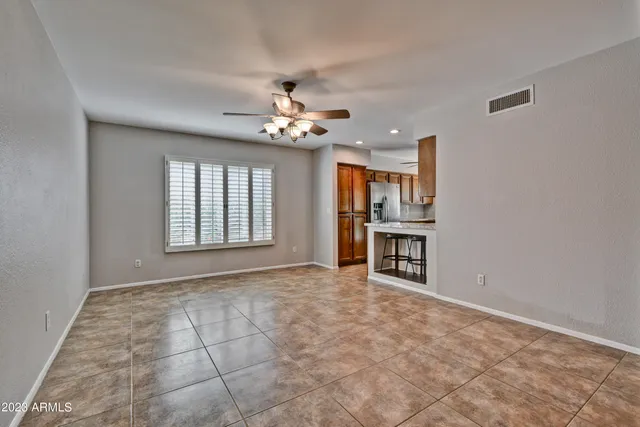 a view of an empty room with a kitchen