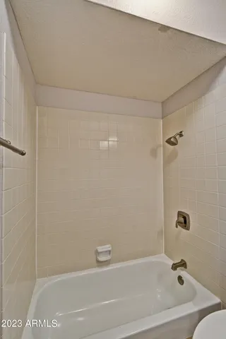a bath tub sitting next to a white sink and vanity