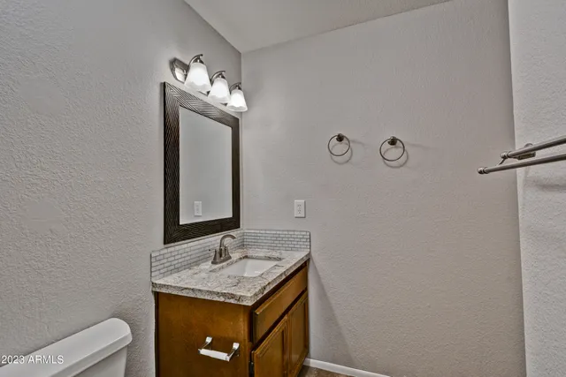 a bathroom with a sink a toilet and mirror