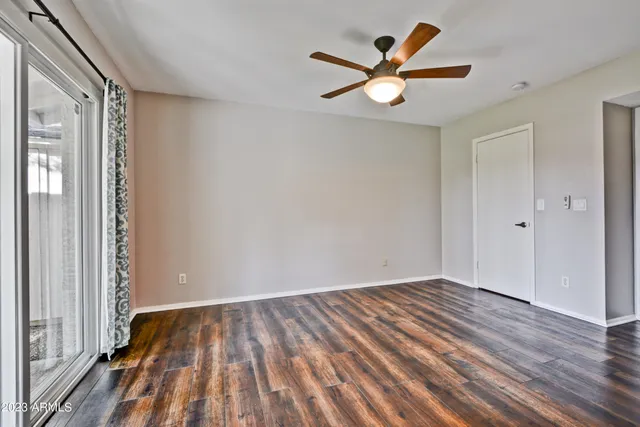 wooden floor in an empty room with a window