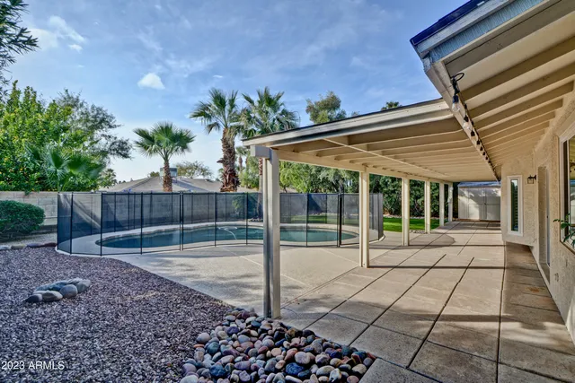 a view of a backyard with wooden fence