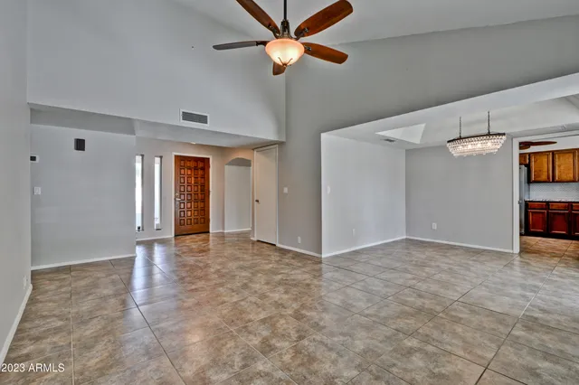 a view of an empty room with a ceiling fan