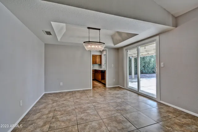 a view of an empty room with a fireplace and a window