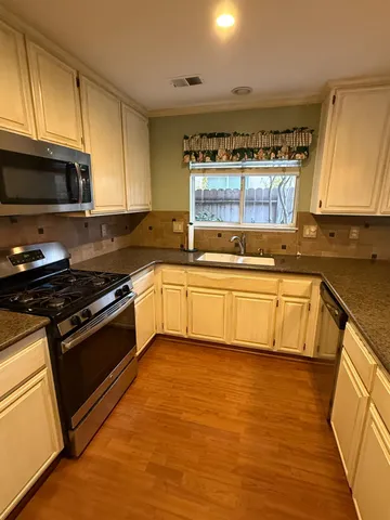 a view of kitchen with sink and cabinets