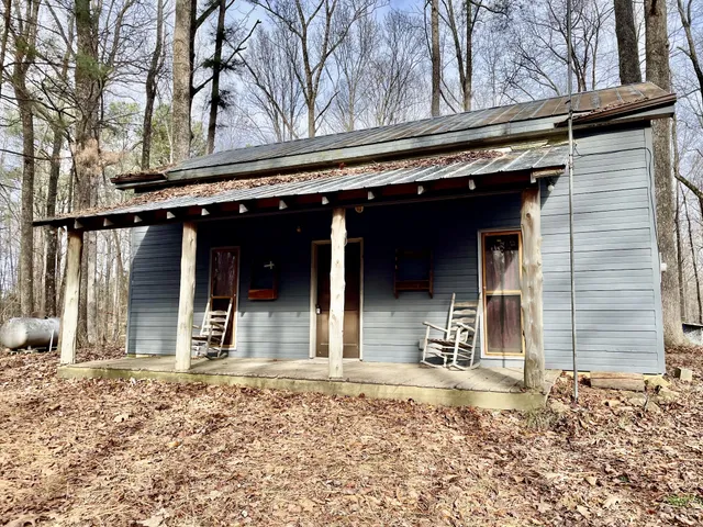 a view of a house with a door and wooden walls