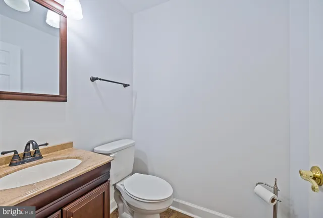 a white toilet sitting next to a bathroom sink