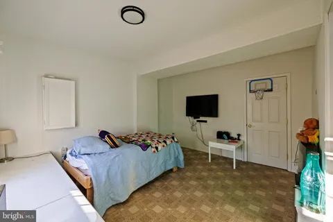 a bed room with a bed and a television