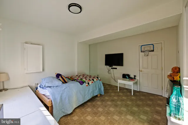 a bed room with a bed and a television