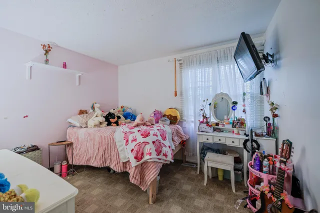 a bedroom with bed and a window