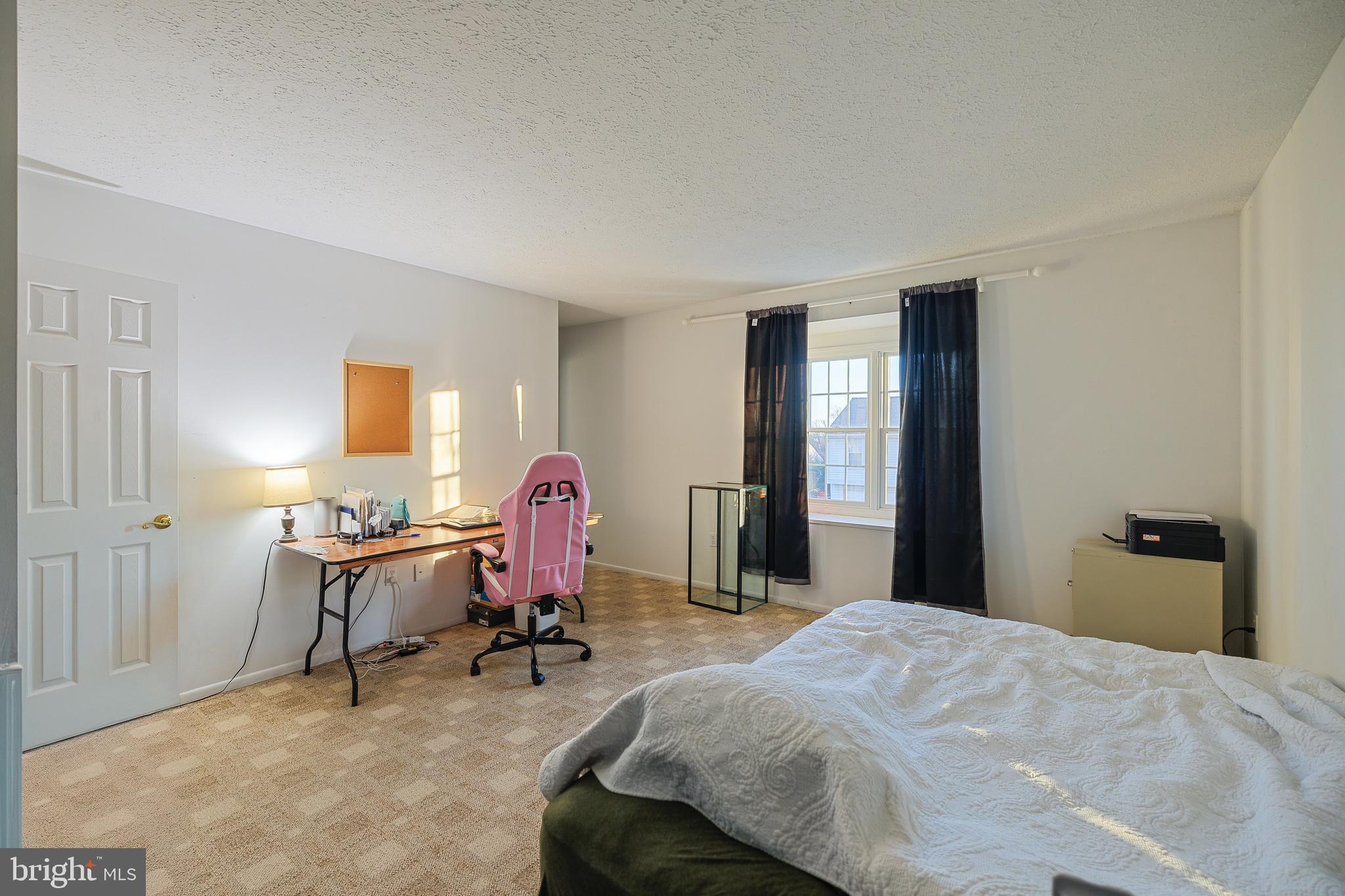 732 Winton Avenue Glen Burnie, MD 21061 - Photo 19 of 27 a bedroom with a bed a desk and chair