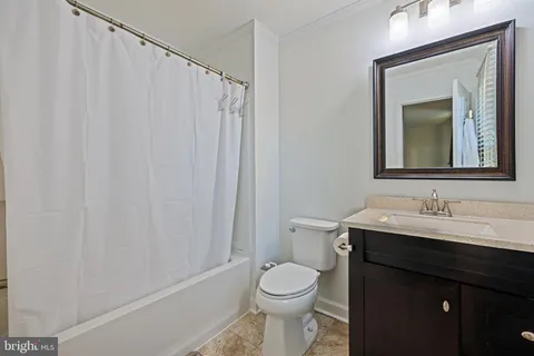 a bathroom with a toilet a sink and a mirror