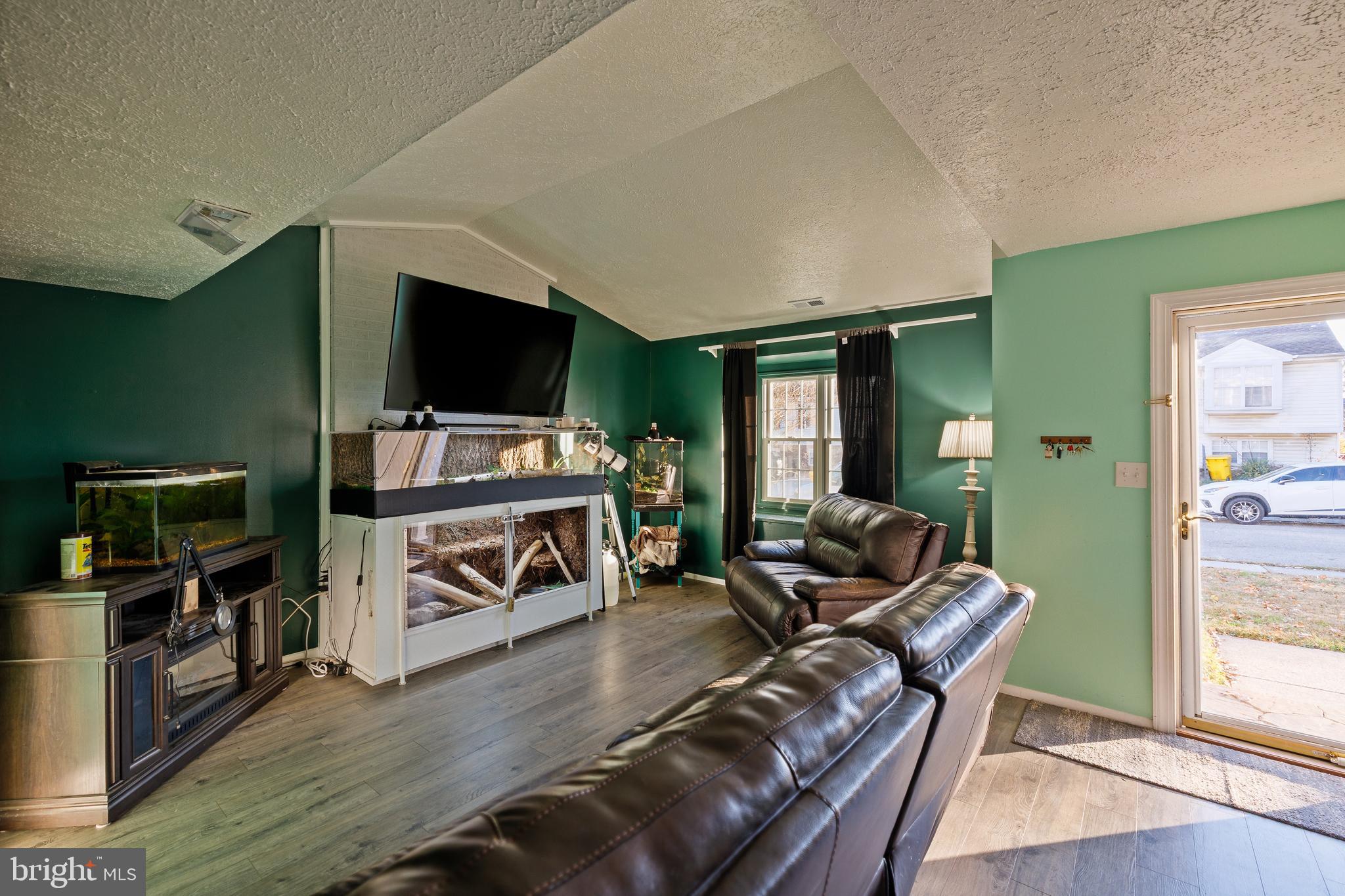 732 Winton Avenue Glen Burnie, MD 21061 - Photo 2 of 27 a living room with furniture and a flat screen tv