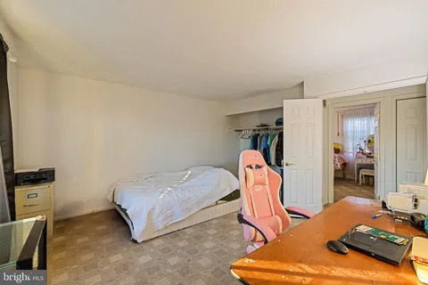 a bedroom with furniture and a gym equipment