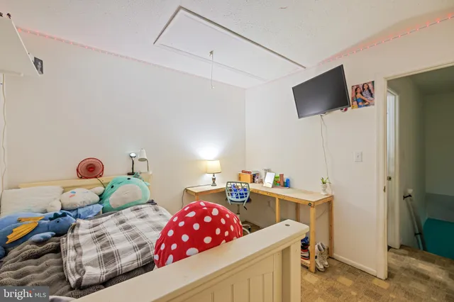 a bedroom with furniture and a flat screen tv