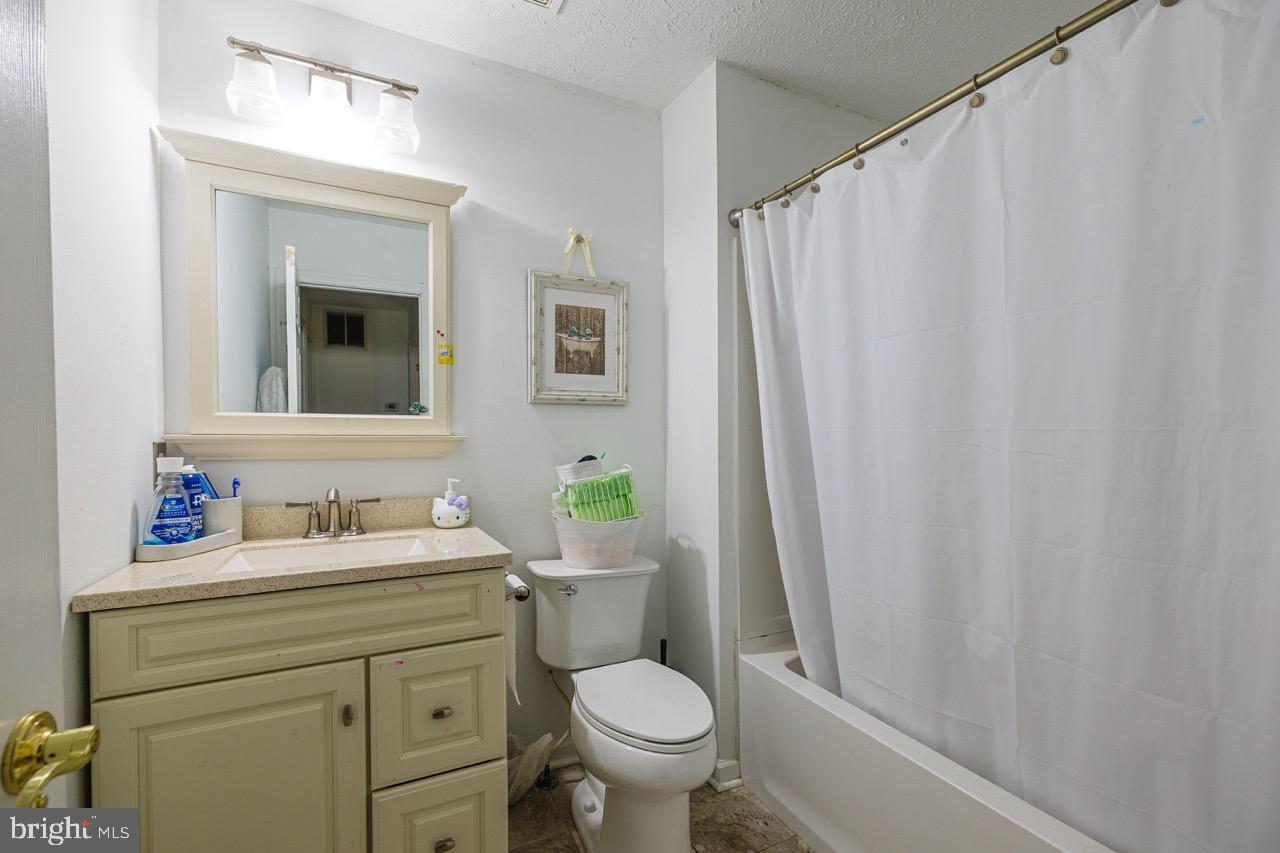 732 Winton Avenue Glen Burnie, MD 21061 - Photo 24 of 27 a bathroom with a toilet sink and mirror