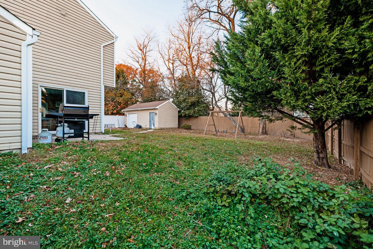 732 Winton Avenue Glen Burnie, MD 21061 - Photo 27 of 27 a view of backyard with barbeque grill and wooden fence