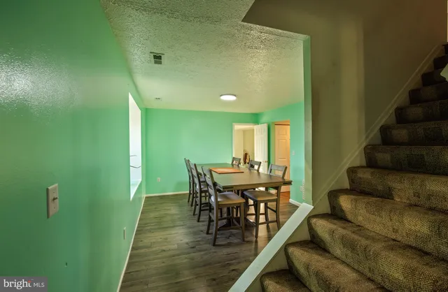 a view of a dining room with furniture and a potted plant