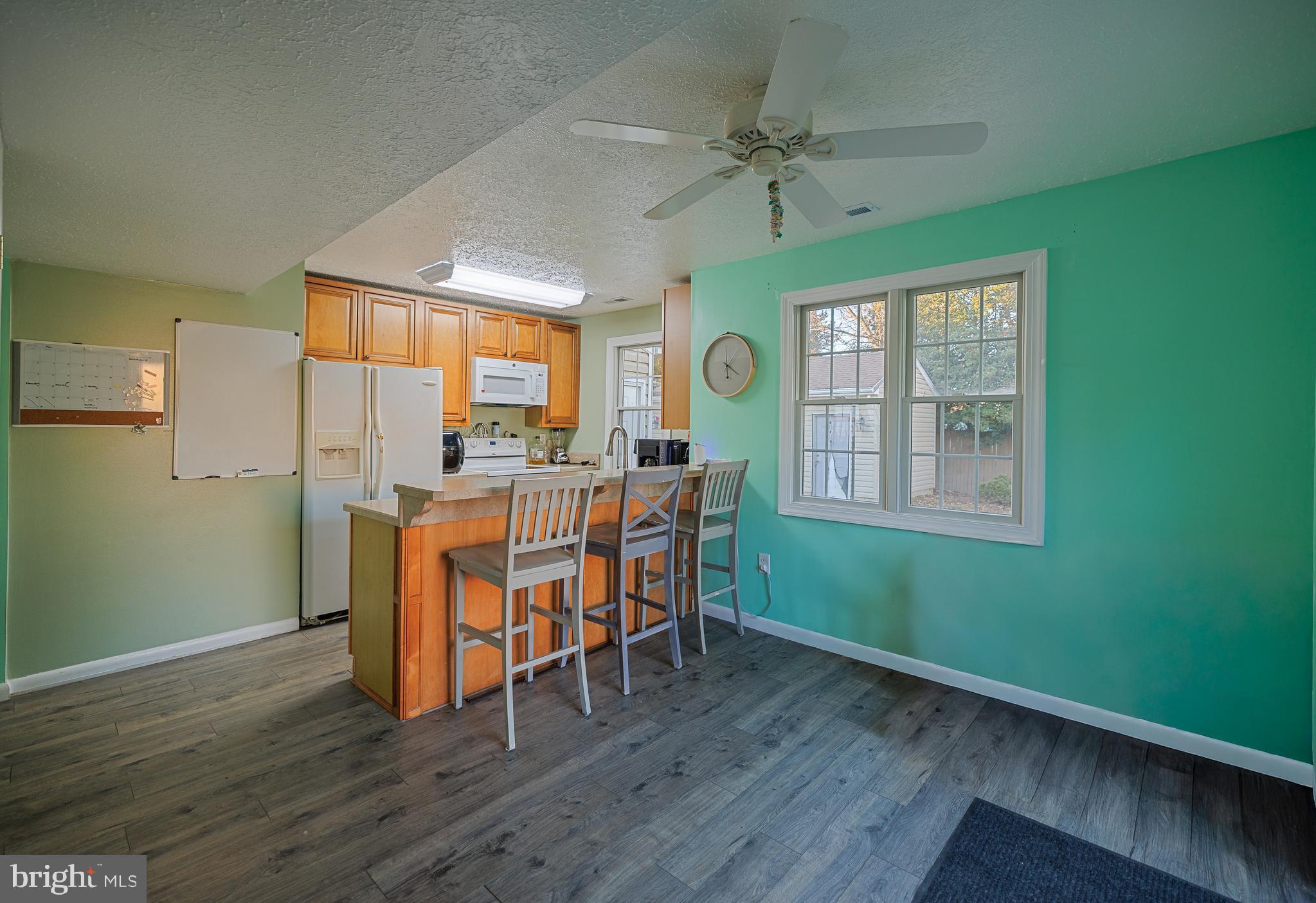 732 Winton Avenue Glen Burnie, MD 21061 - Photo 10 of 27 a dining room with furniture a floor to ceiling window and wooden floor