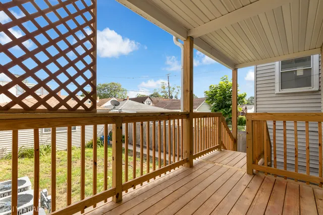 a view of a balcony with wooden floor
