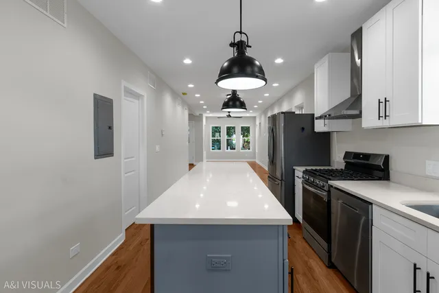 a kitchen with a sink a refrigerator and cabinets