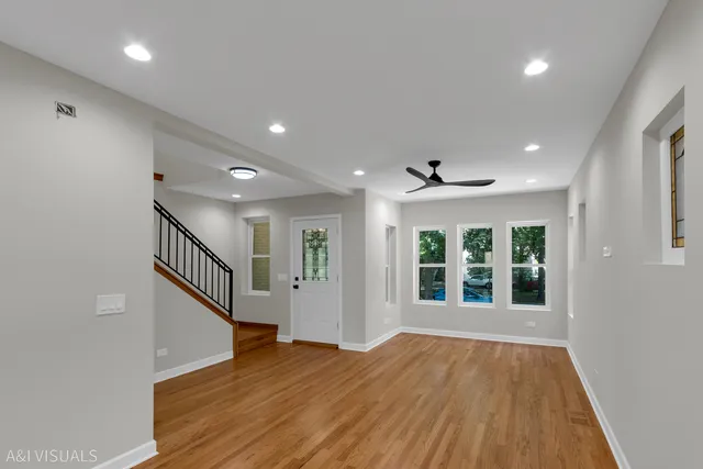 a view of an entryway with wooden floor and door