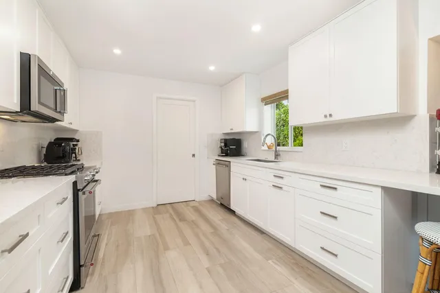 a kitchen with a sink stove and cabinets