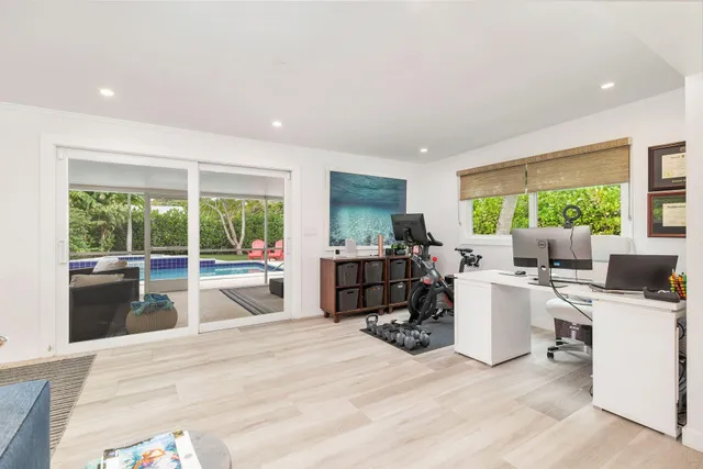 a living room with furniture a large window and a table