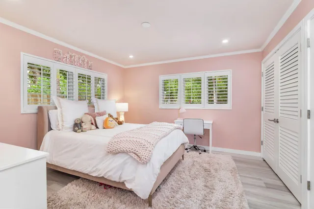 a bedroom with a large bed and a window