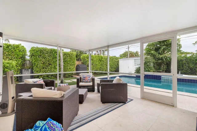 a living room with furniture and a floor to ceiling window