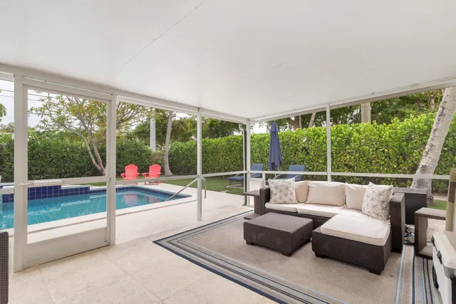 a living room with couch and a floor to ceiling window