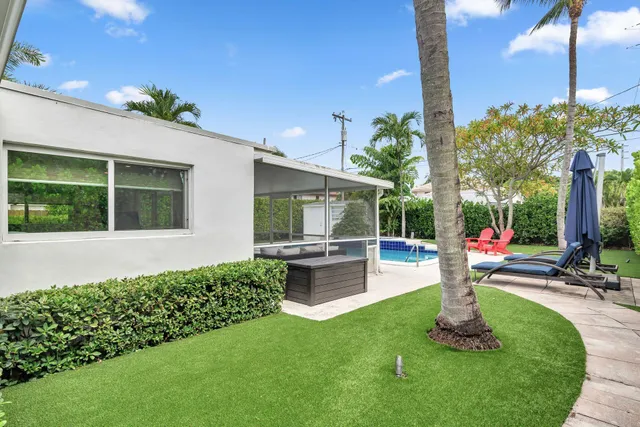 a view of a house with a backyard and porch