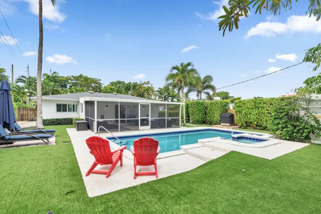 a view of a house with a backyard patio and swimming pool