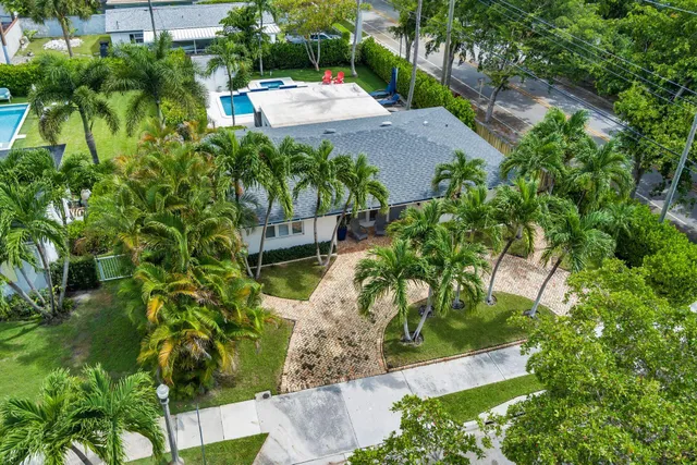 an aerial view of a house with a yard basket ball court and outdoor seating
