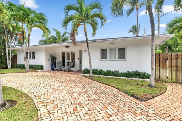 a view of a chair and tables in the patio of a house