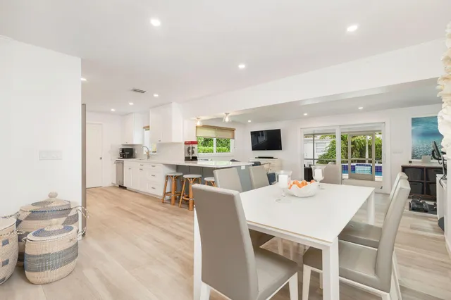 a view of a dining room with furniture and a kitchen